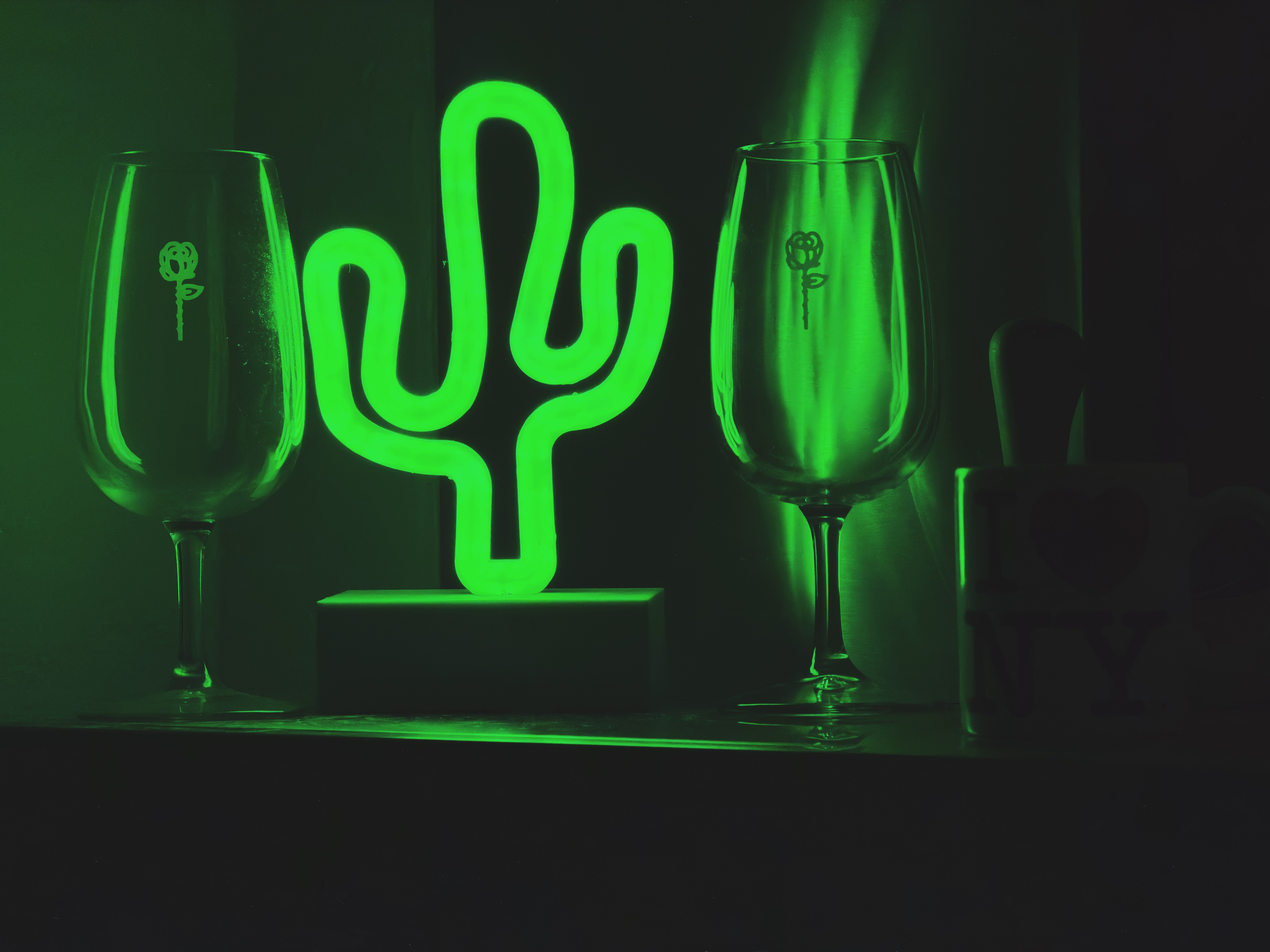 Neon cactus with wine glasses