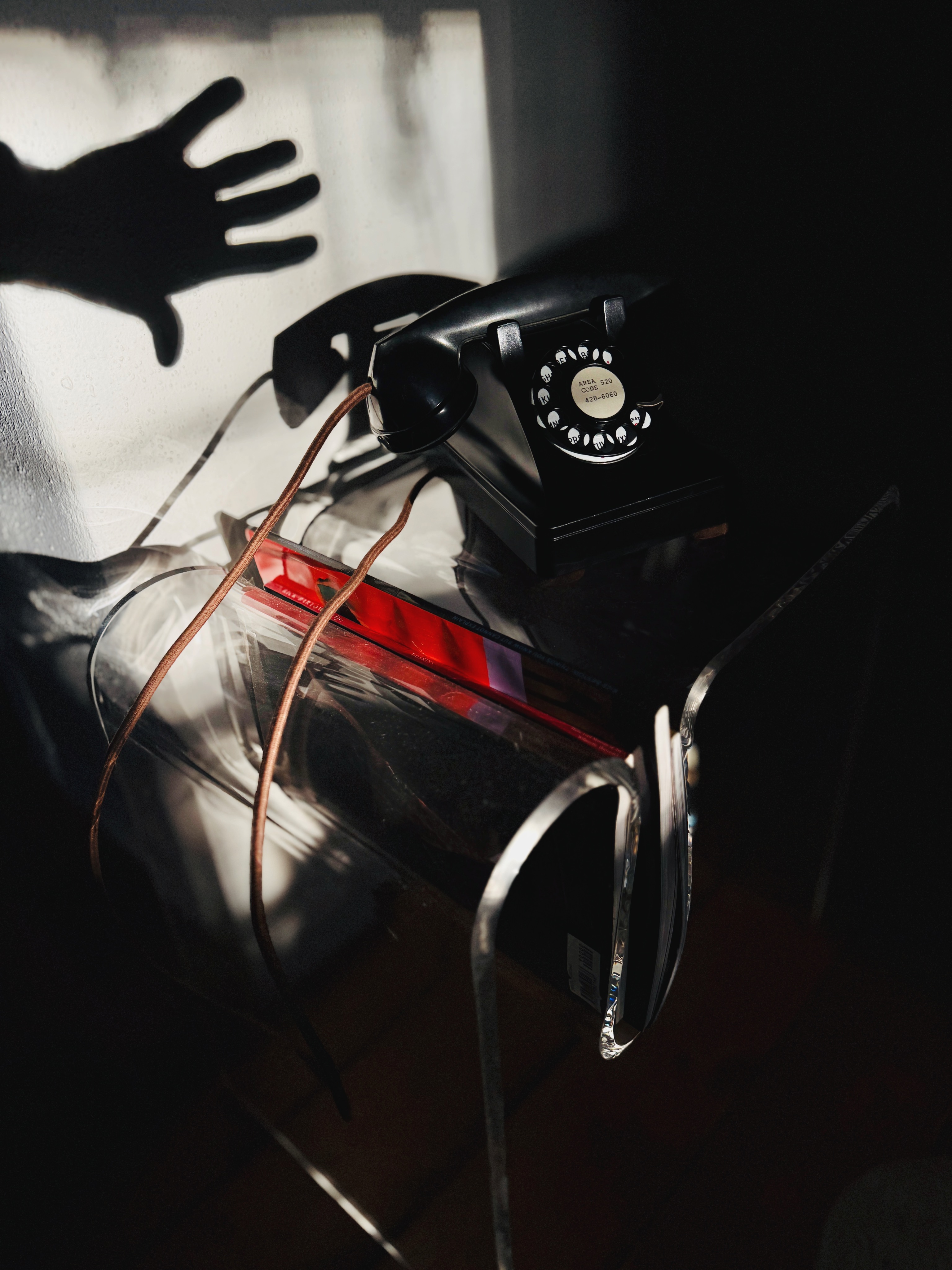 Vintage rotary phone with shadow hand