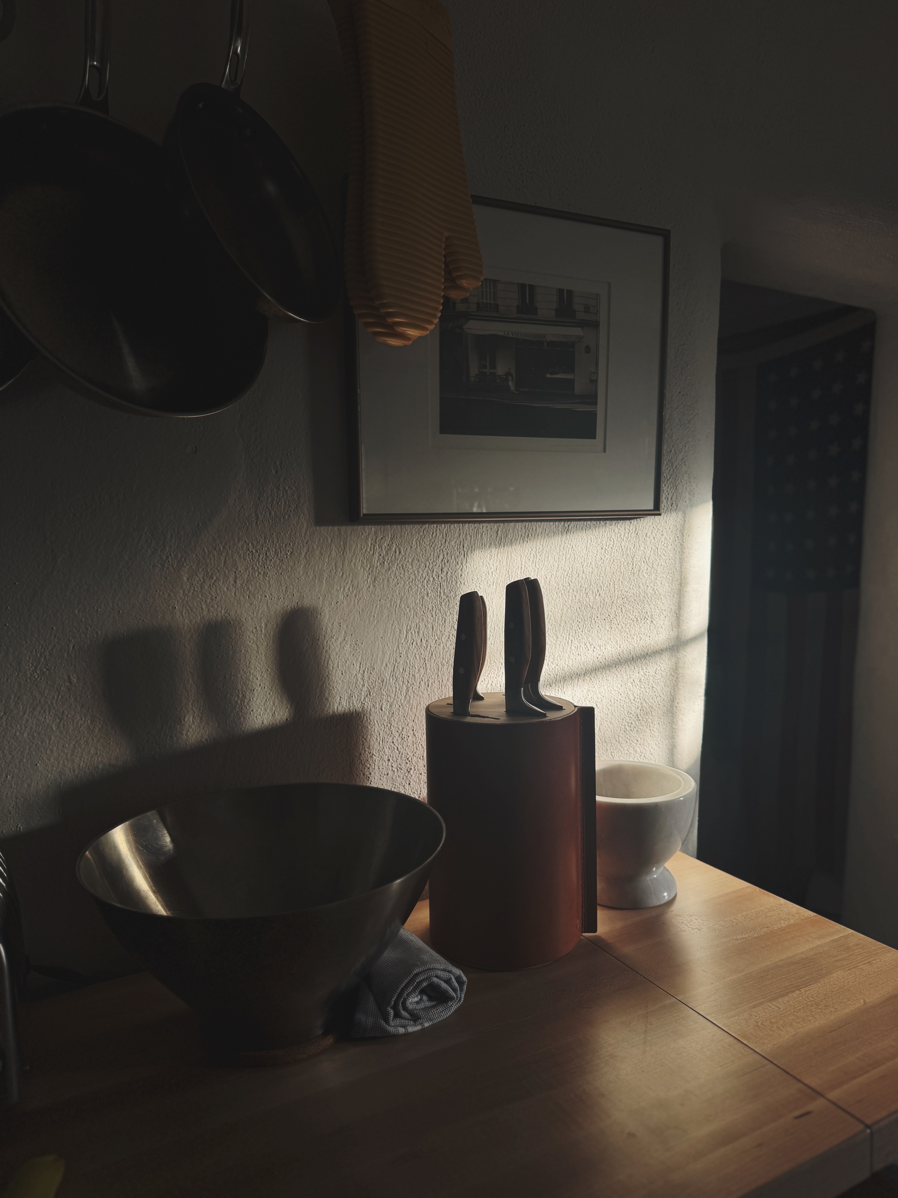 Kitchen counter with knives and art