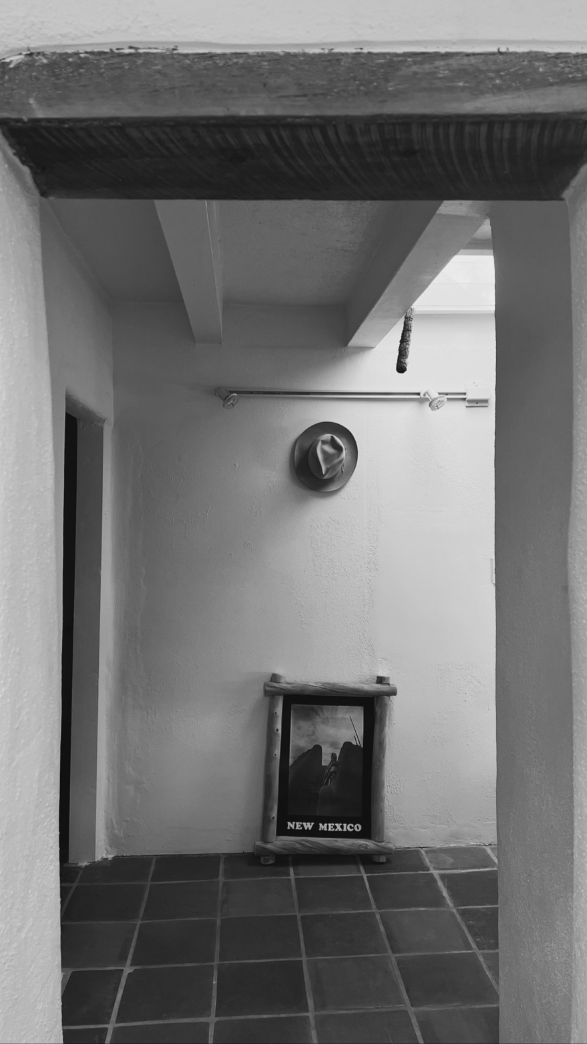 Adobe hallway with New Mexico poster