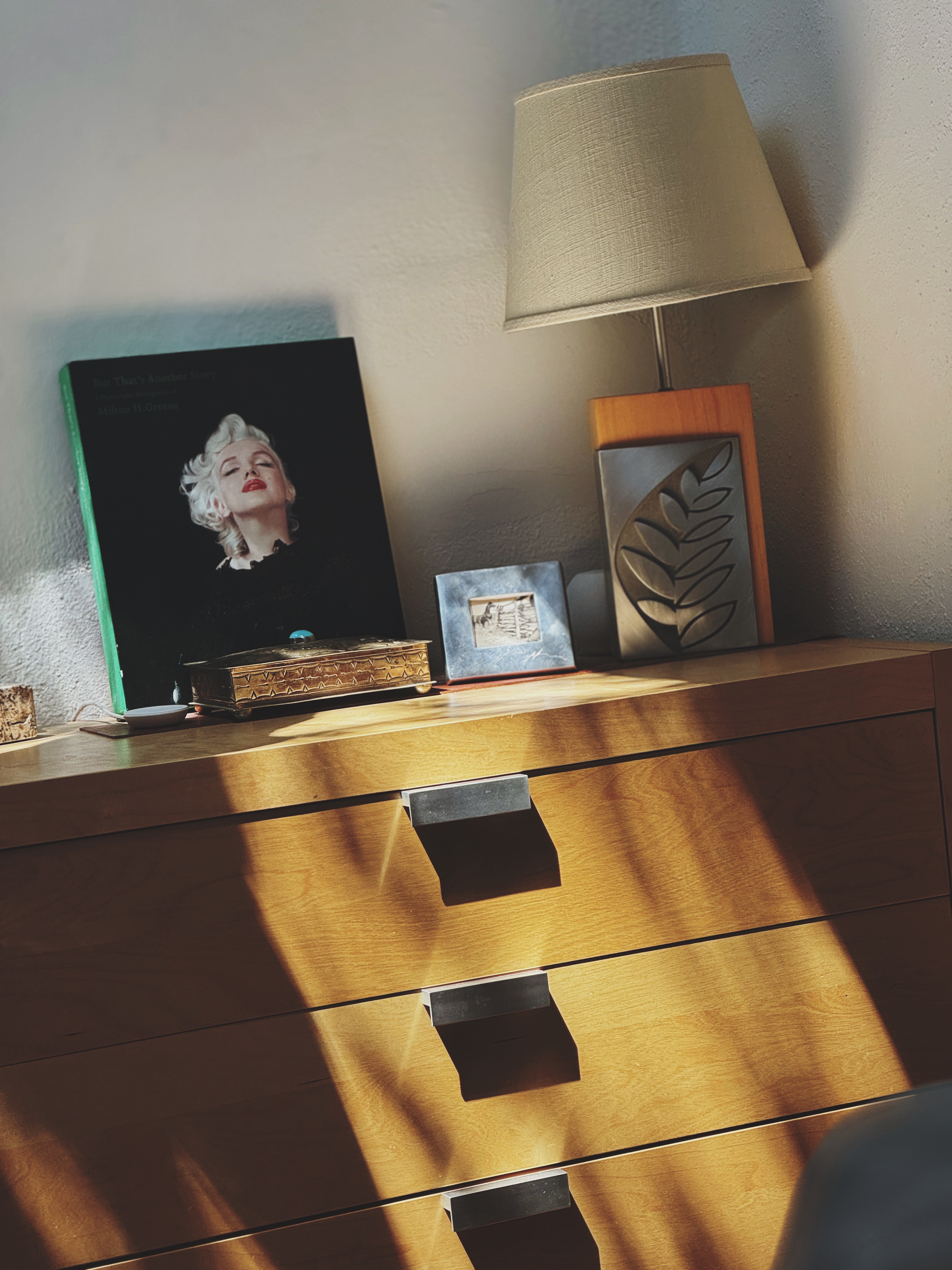 Dresser with Marilyn Monroe book and lamp